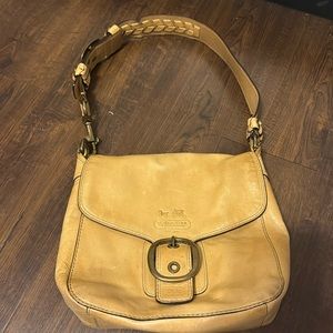 This coach bag comes with a wallet! It is a very good bag with lots of room!